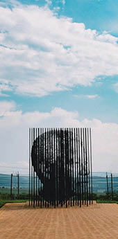 A mountain with a peak overlooking a city. AI generated content