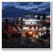 A man and woman are sitting on the ground in front of a tent. The woman is holding the man. AI generated content