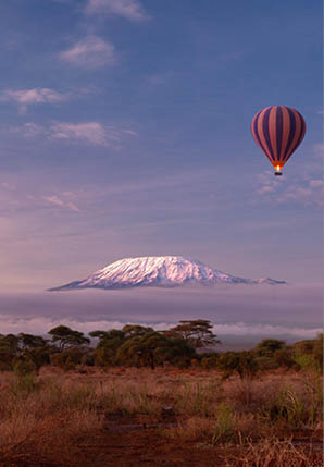 A hot air balloon is flying over a mountain. Description generated by AI