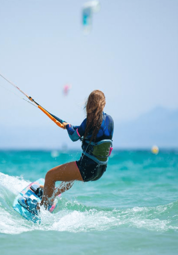 young woman practicing kite surfing