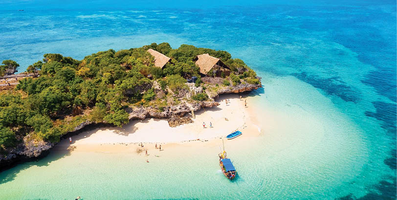 A small island with a sandy beach and a blue boat on it. Description generated by AI