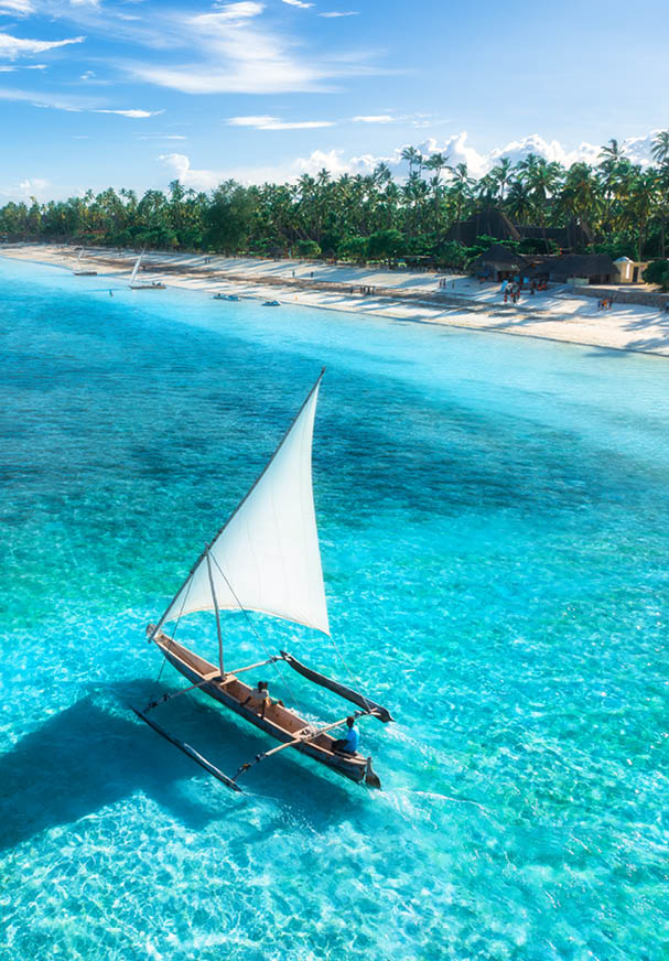 A white sailboat on the water. Description generated by AI