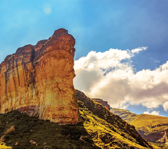Scenic color panoramic South Africa Drakensberg Golden Gate national park landscape - impressive nature with golden red rock landmark and blue sky and clouds 
