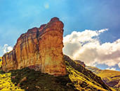 Scenic color panoramic South Africa Drakensberg Golden Gate national park landscape - impressive nature with golden red rock landmark and blue sky and clouds 