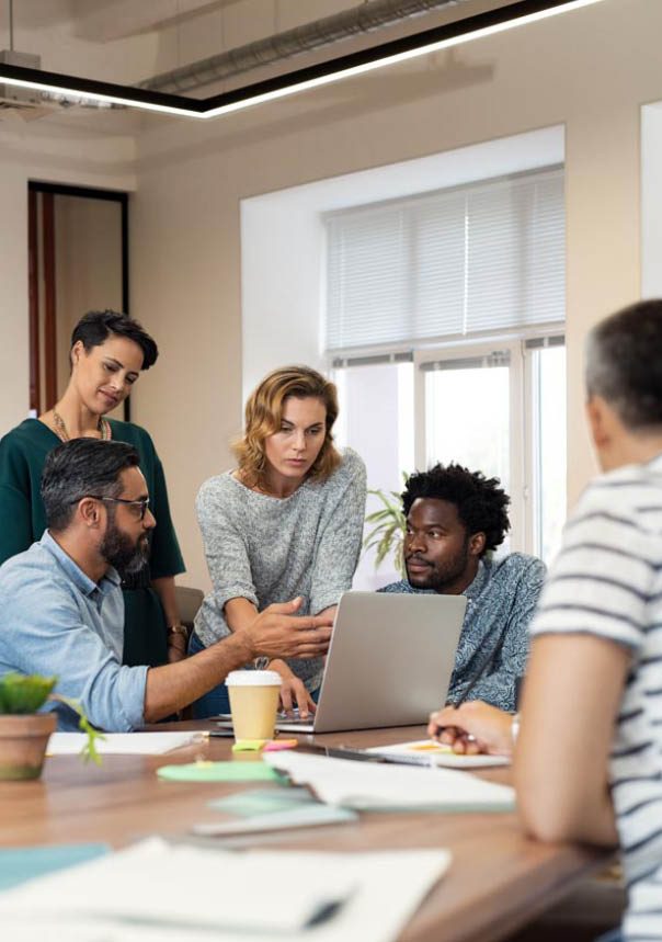 Busy multiethnic partners gathered to discuss some urgent matters. Group of creative businessmen and casual businesswomen discussing a new project in the office. Working together concept.