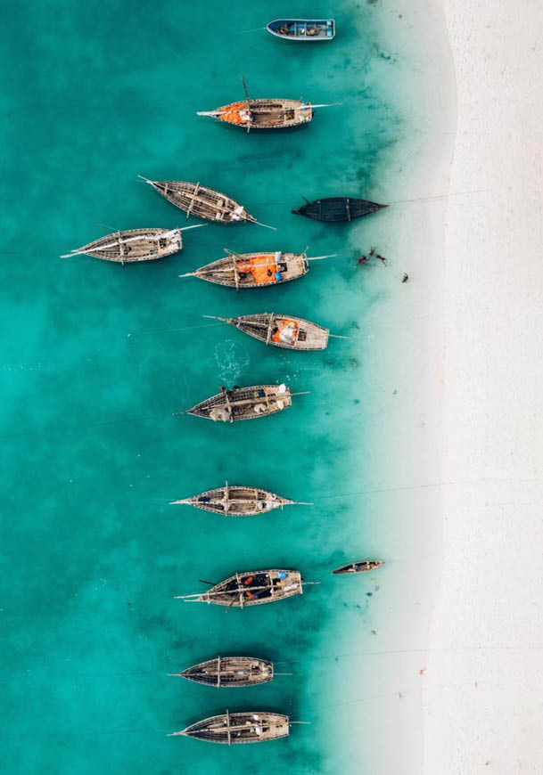Top view or aerial view of Beautiful crystal clear water and white beach with long tail boats in summer of Zanzibar island