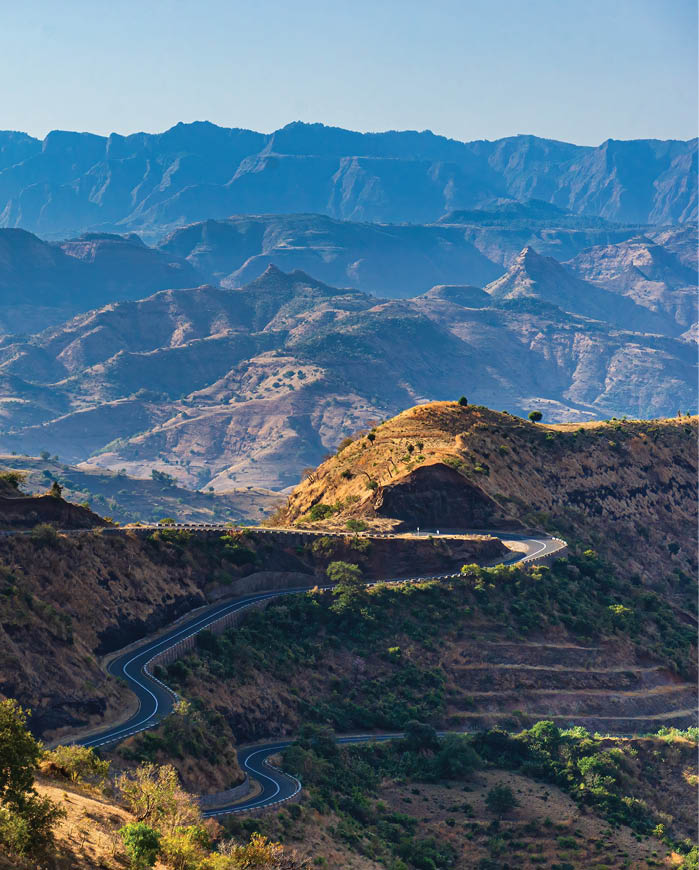 A winding road in a mountainous area. Description generated by AI