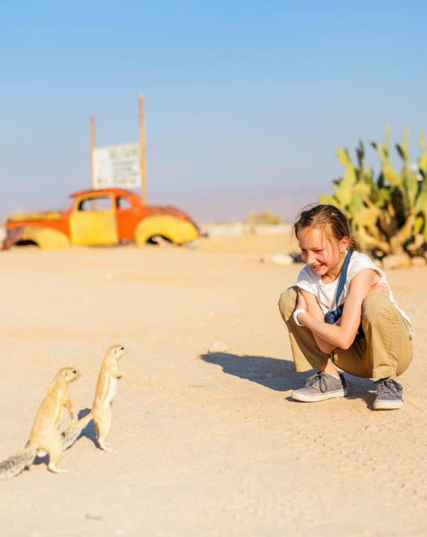 Adorable girl looking at little ground squirrels outdoors