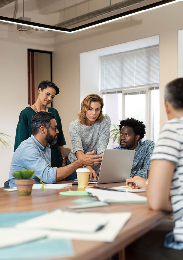 Busy multiethnic partners gathered to discuss some urgent matters. Group of creative businessmen and casual businesswomen discussing a new project in the office. Working together concept.