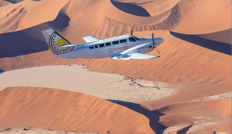 A small airplane is flying over a sandy desert landscape. AI generated content