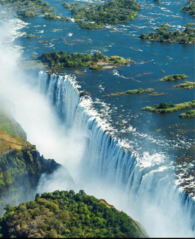 The Victoria falls is the largest curtain of water in the world (1708 m wide). The falls and the surrounding area is the National Parks and World Heritage Site (helicopter view) - Zambia, Zimbabwe