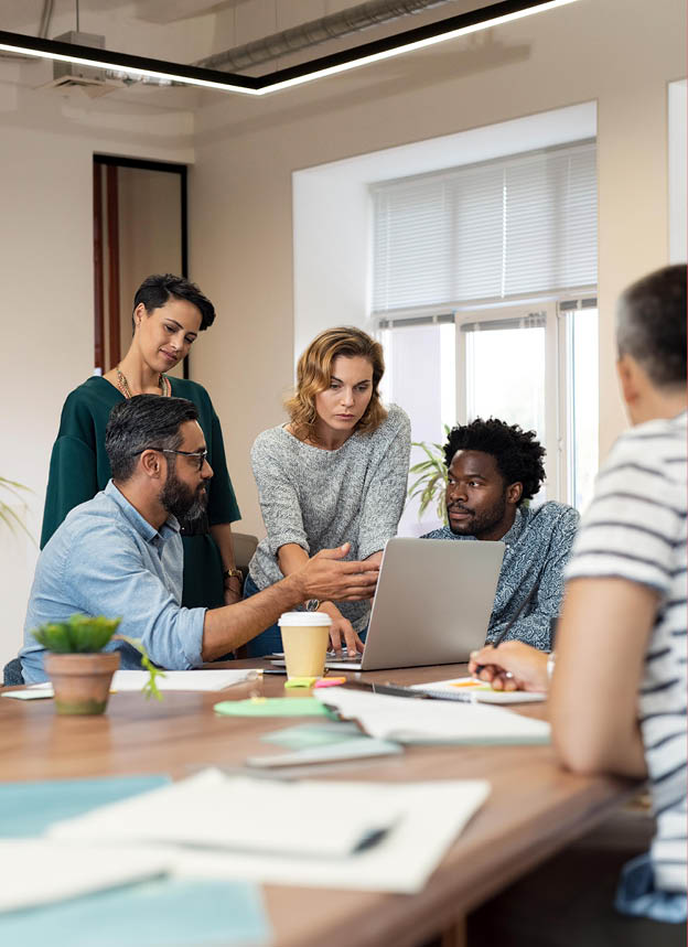 Busy multiethnic partners gathered to discuss some urgent matters. Group of creative businessmen and casual businesswomen discussing a new project in the office. Working together concept.