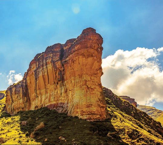 Scenic color panoramic South Africa Drakensberg Golden Gate national park landscape - impressive nature with golden red rock landmark and blue sky and clouds 