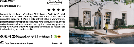 A white hotel with a green door. Description generated by AI