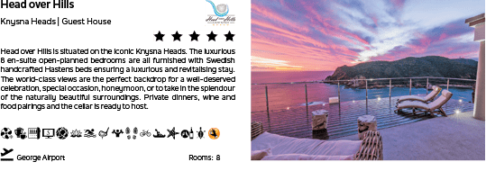 A large house with a patio and a view of the ocean. Description generated by AI