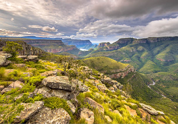 A mountain with a rocky terrain and a valley below. Description generated by AI