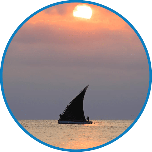 Silhouette of fishing boat in the sea at sunset