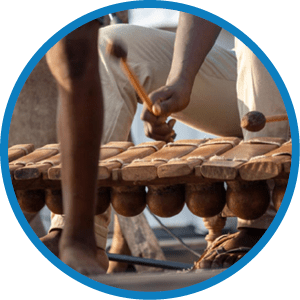 People dancing to traditional cultural heritage Mozambican wood xylophone like instrument known as timbila or mbila played with rubber drum sticks